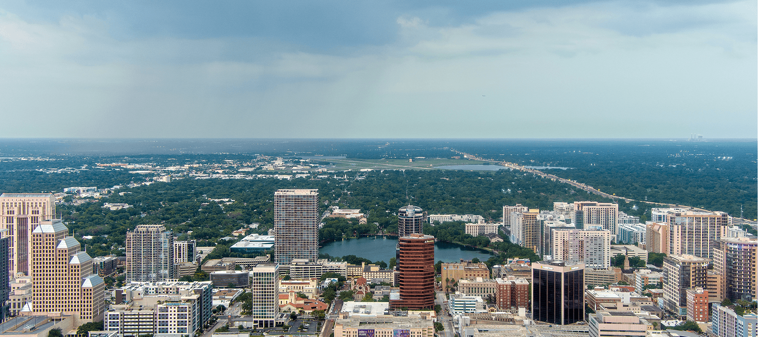 City skyline with buildings and cloudy sky.