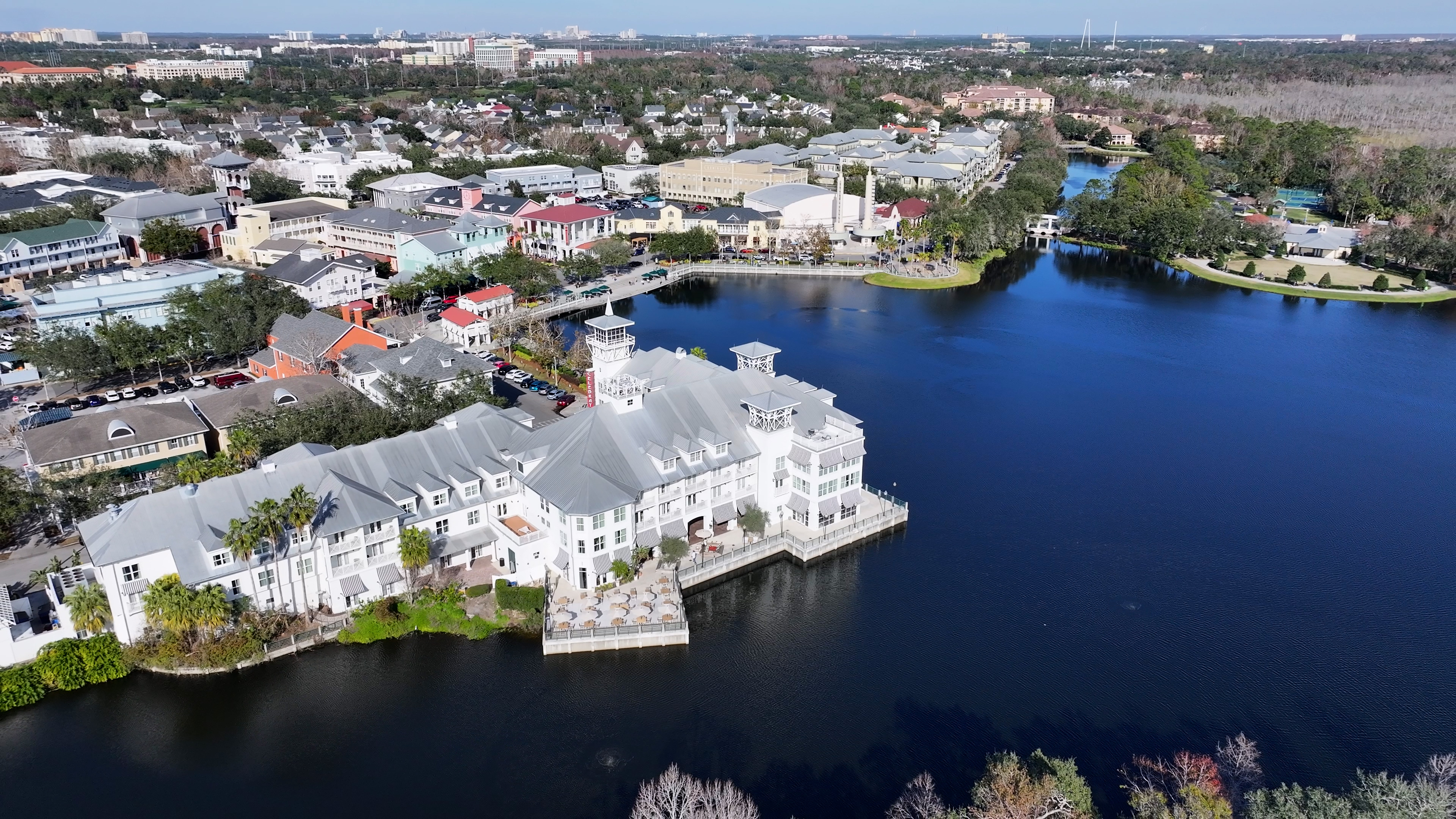 Aerial view of waterfront buildings and lake.