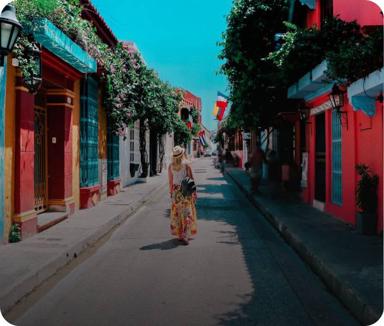 Woman walking on colorful, vibrant street.