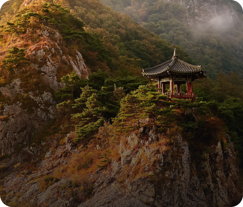 Mountain pavilion surrounded by lush greenery.