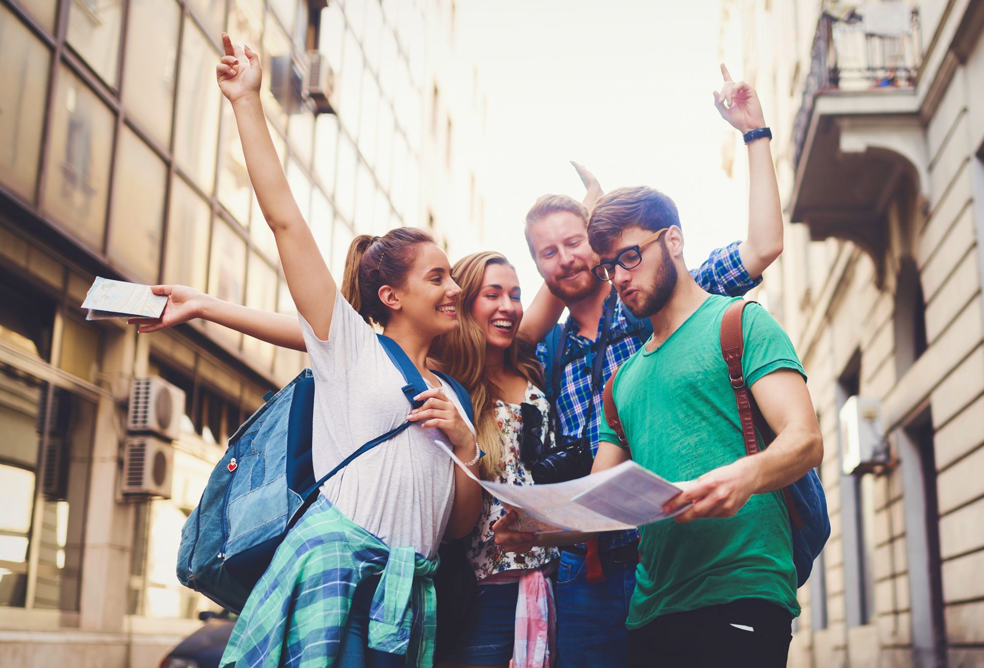 Group of friends exploring city with map.