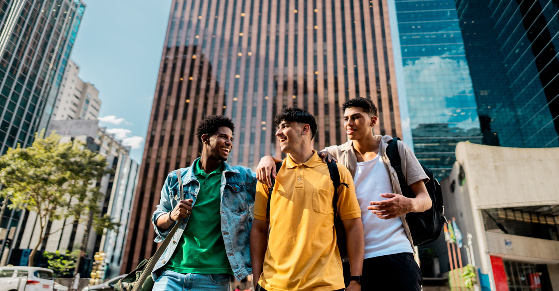 Three friends walking in the city.
