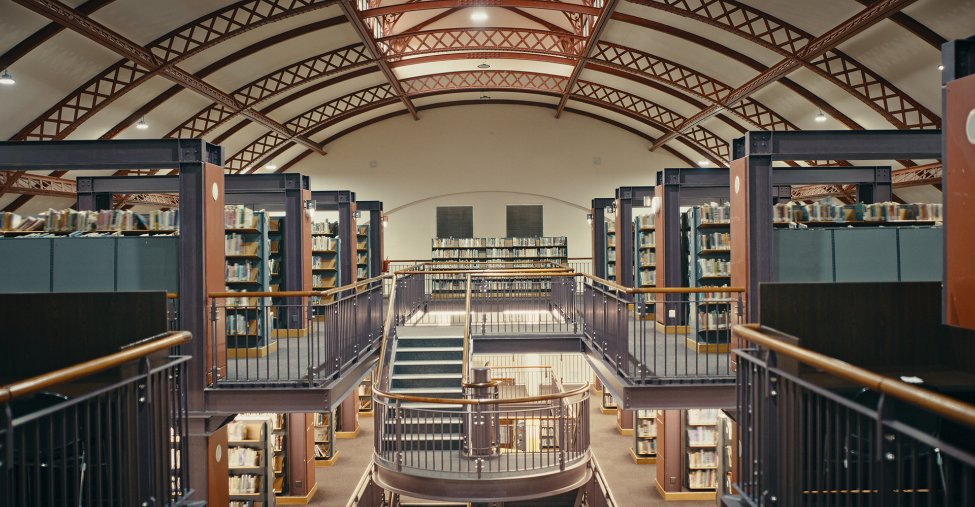 Library interior with bookshelves and balconies.